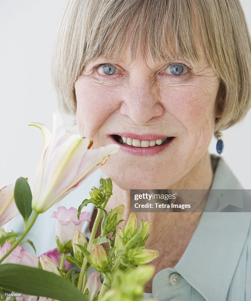 Close up of senior woman and flowers