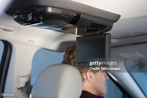 television screen in car with man driving - dvd player in car stock pictures, royalty-free photos & images