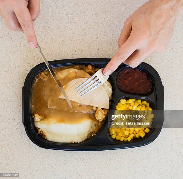 close up of man eating tv dinner - tv dinner stock pictures, royalty-free photos & images