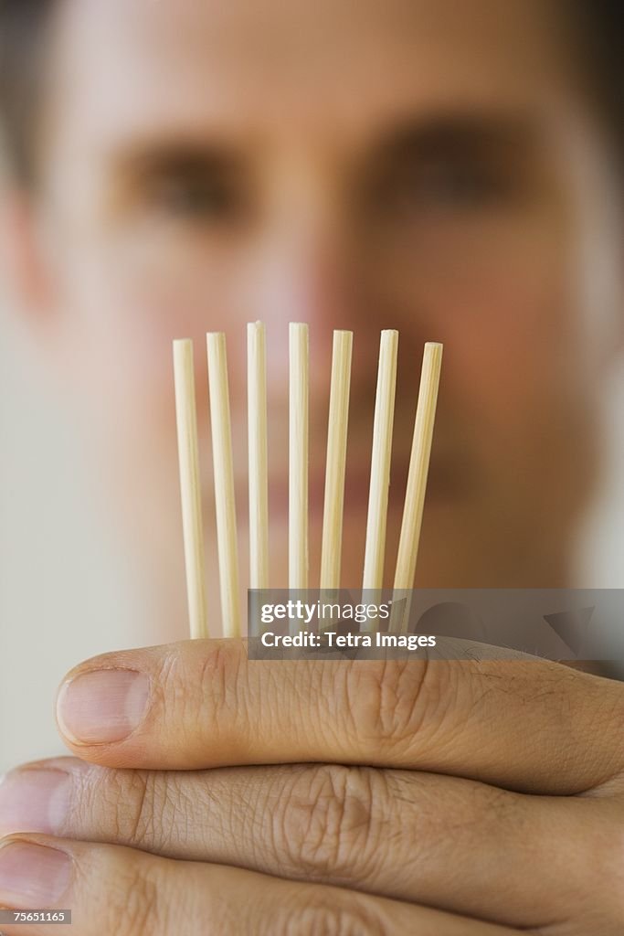 Man holding toothpicks