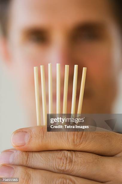 man holding toothpicks - bad luck stock pictures, royalty-free photos & images