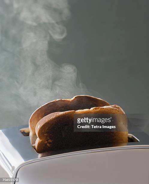 toast burning in toaster - burnt foto e immagini stock