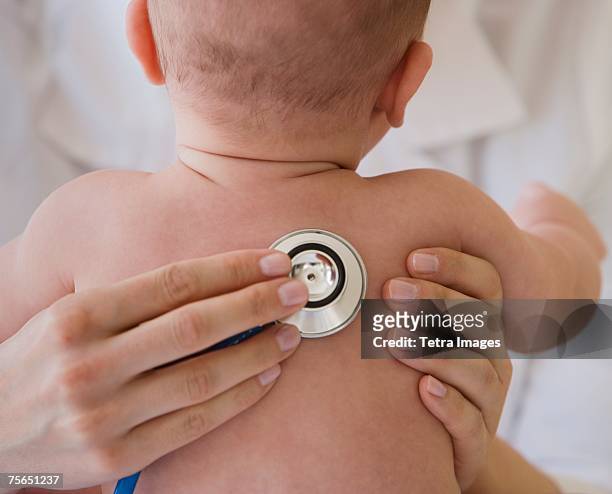doctor listening to baby's lungs - pediatric imagens e fotografias de stock