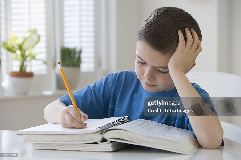 Boy doing homework at table