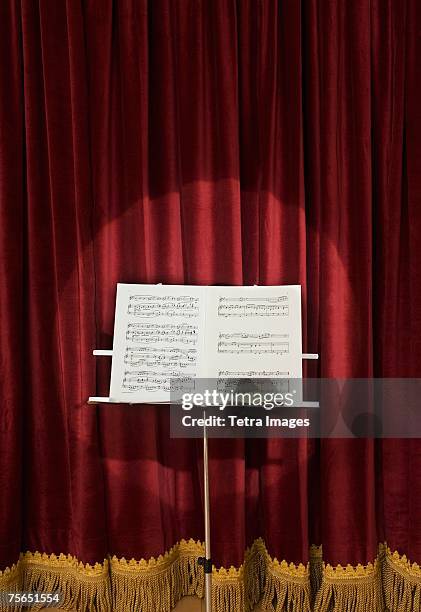 spotlight on sheet music on stage - empty concert venue stock pictures, royalty-free photos & images