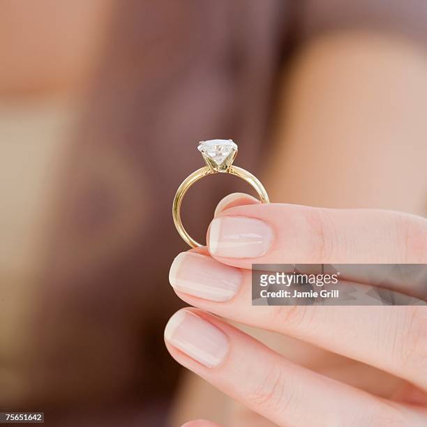 woman holding engagement ring - ring stock-fotos und bilder