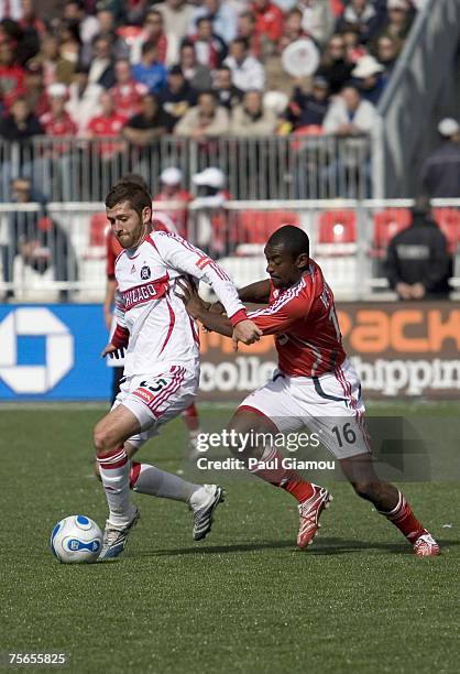 Toronto FC defender Marvell Wynn pushes off from Chicago Fire defender Gonzalo Segares during the match at BMO Field, in Toronto , Ontario, Canada on...