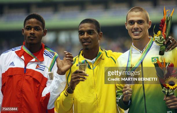 Rio de Janeiro, BRAZIL: Jamaica's Maurice Smith, Cuba's Yordan Garcia and Brazil's Carlos Chinin show their medals in Men's Decathlon at the XV Pan...