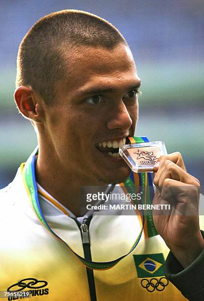 Rio de Janeiro, BRAZIL: Carlos Chinin from Brazil jokes biting his Bronze medal in Men's Decathlon at the XV Pan American Games 2007 in Rio de...