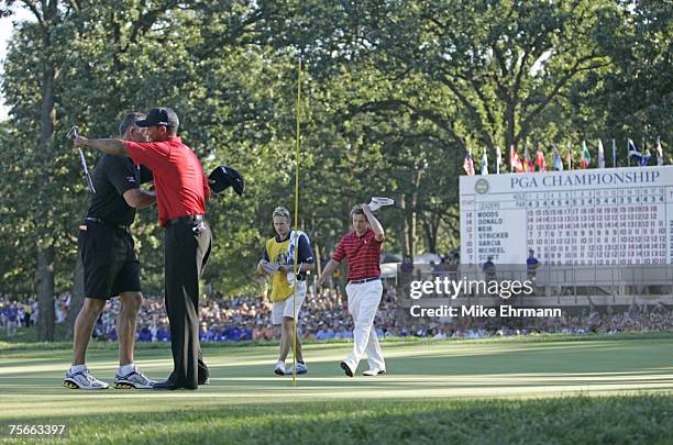 Tiger Woods hugs caddy Steve Williams after winning the 88th PGA Championship at Medinah Country Club in Medinah, Illinois, on August 20, 2006.