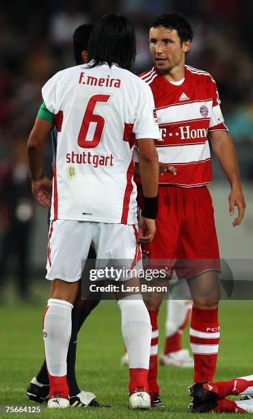 Fernando Meira of Stuttgart battles with MArk van Bommel of Munich during the Premiere Liga Cup Semi-final match between VfB Stuttgart and FC Bayern...