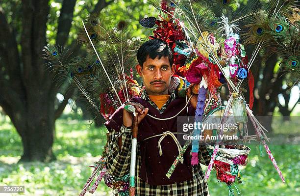 Hindu pilgrims march near Lucknow toward the northern Indian city of Ayodhya, March 8, 2002 carrying kawaria's which are filled with water from holy...