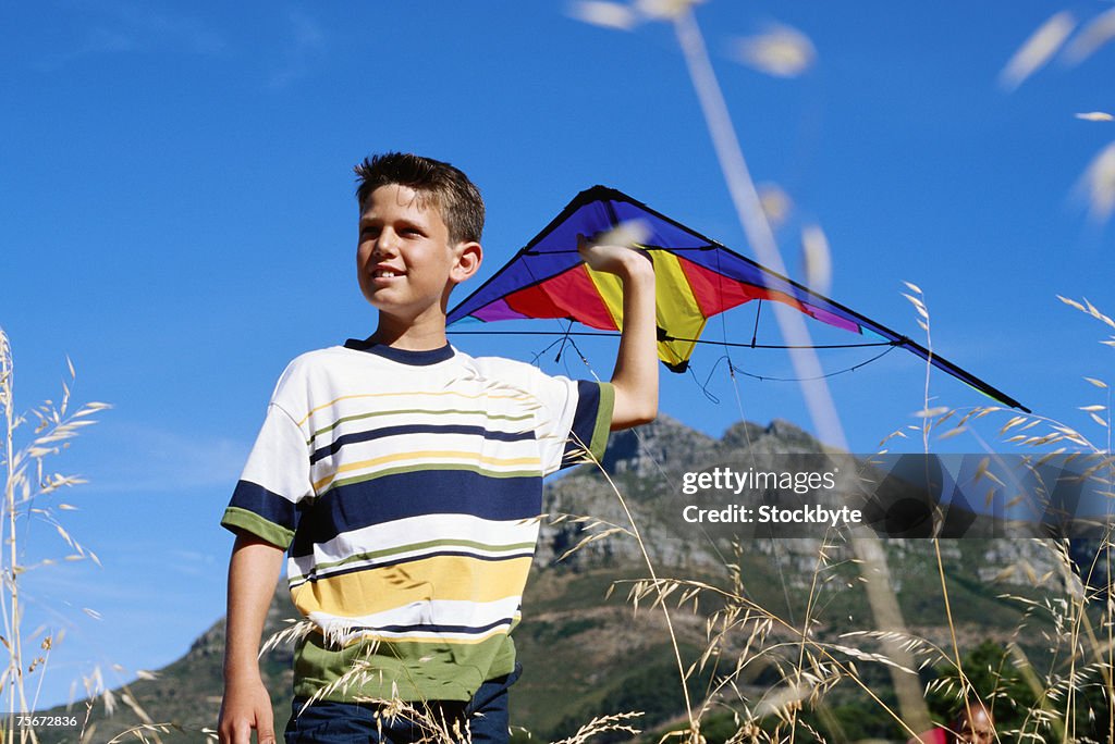 Boy (4-7) playing with kite, low angle view