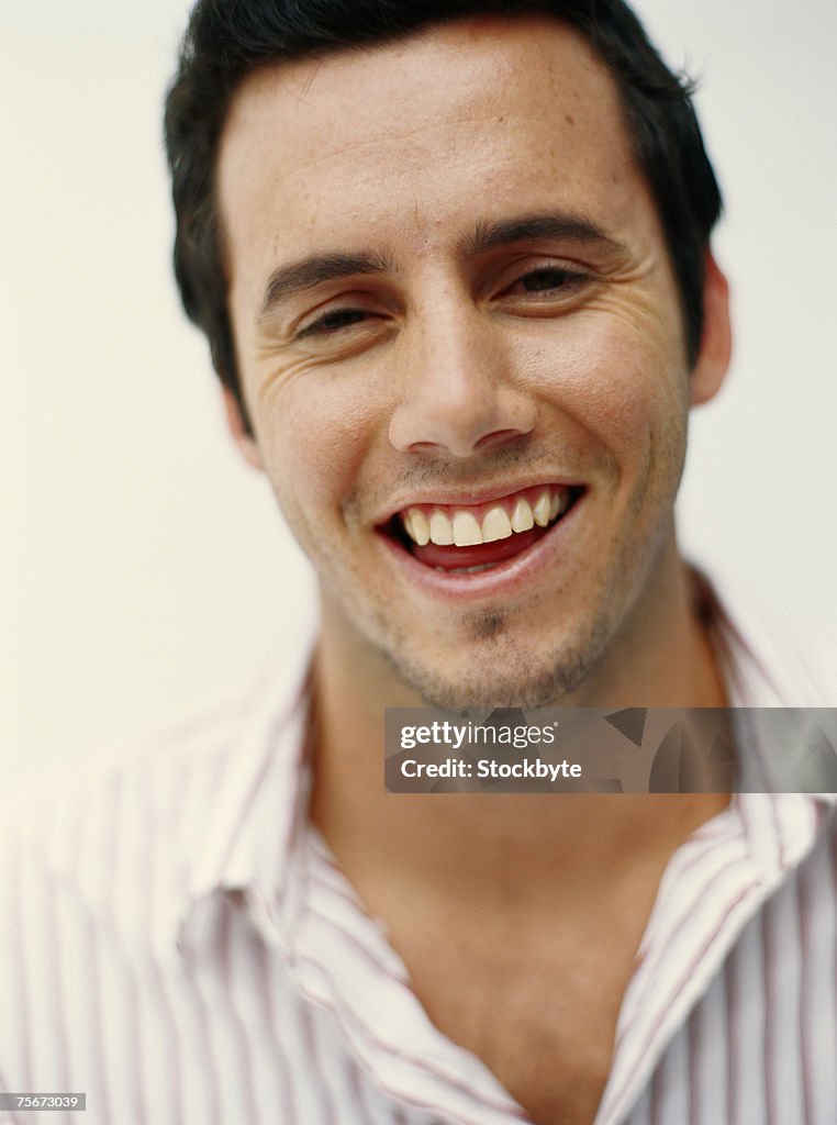 Young man smiling, close-up, portrait