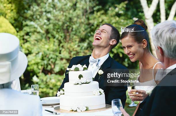 newlywed couple at wedding reception - wedding couple laughing photos et images de collection