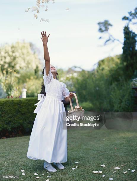 flower girl (4-7) collecting flower petals - flower girl stock pictures, royalty-free photos & images