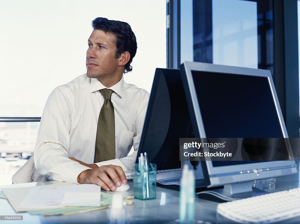 Businessman sitting at desk using computer