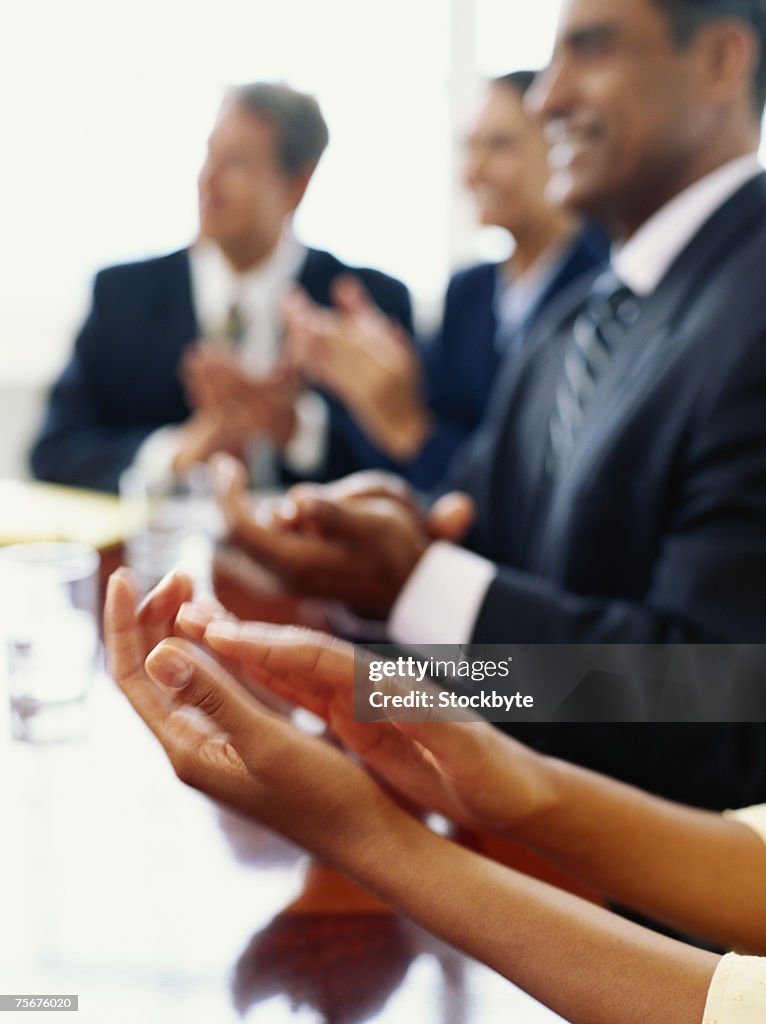 Businesspeople clapping hands