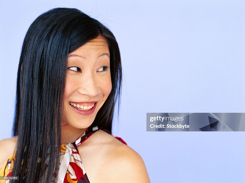 Young woman smiling, looking away, close-up