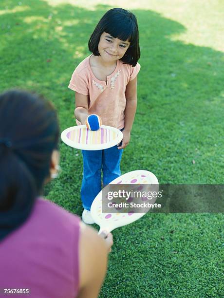 girl (4-5) playing paddle ball in park, elevated view - paddle ball stock pictures, royalty-free photos & images