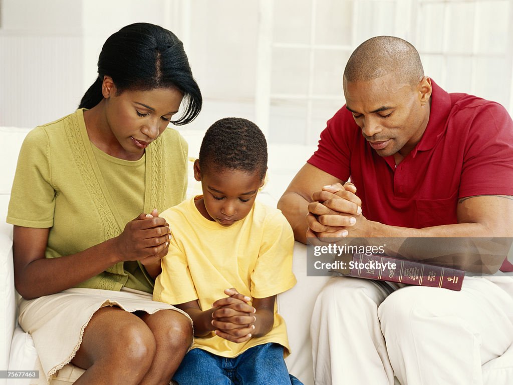 Parents with son (6-9) praying