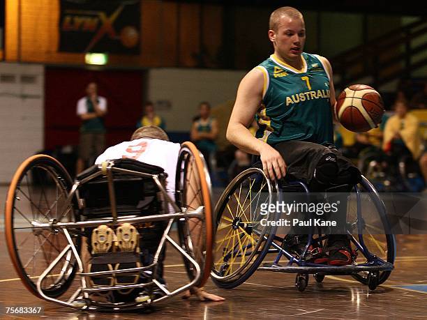 Shaun Norris of the Rollers dribbles past Jon Pollock of Great Britain during game two of the four-game international wheelchair basketball series...
