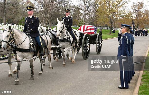 The remains of Air Force Col. William C. Coltman are taken to his final resting place during a burial service at Arlington National Cemetery April 3,...