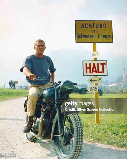 American actor Steve McQueen stars as Captain Virgil 'The Cooler King' Hilts in World War II drama 'The Great Escape', 1963. Here he poses on his...