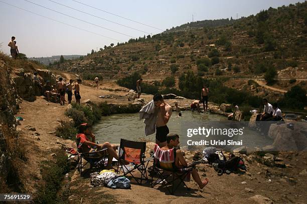 Israelis enjoy a hot summer day at a water spring July 26, 2007 near the West Bank village of Walajeh.