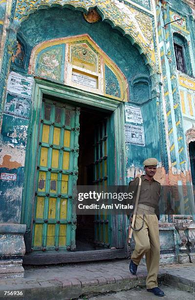 Police guard a shrine March 10, 2002 in the controversial northern Indian city of Ayodhya. Both Muslims and Hindus regard the city as holy and the...