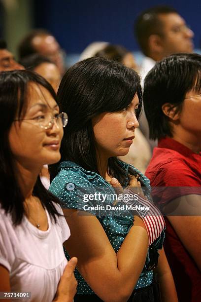 Immigrants say the Pledge of Allegiance after being sworn in as US citizens during naturalization ceremonies on July 26, 2007 in Pomona, California....