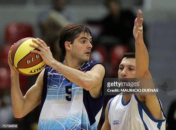 Rio de Janeiro, BRAZIL: Argentina's Diego Garcia is marked by Uruguay's Nicolas Mazzarino during a XV Pan American Games basketball game 26 July 2007...