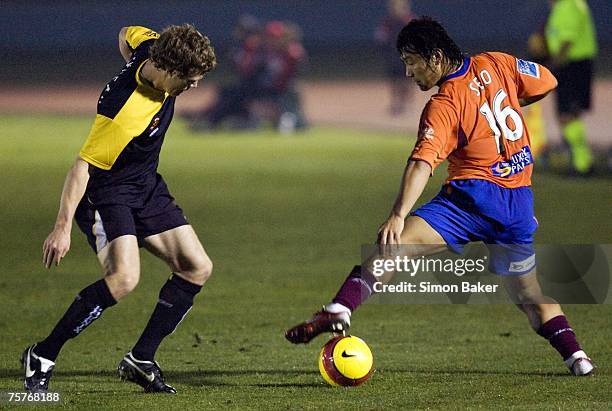 Tony Lochhead of the Phoenix and Hyuk-Su Seo of the Roar in action during the A-League pre-season cup match between the Wellington Phoenix and the...