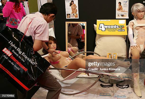 Visitor touches a sex doll as Japan holds Asias largest Adult Expo at Makuhari Messe July 27, 2007 in Chiba, Japan. The frist Adult Expo held in...