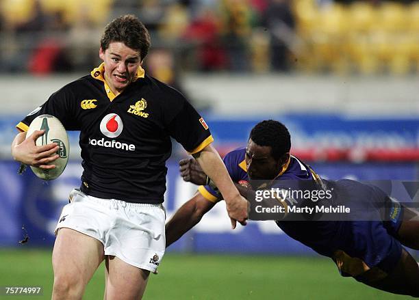 Dane Coles of the Lions runs in a try as he is tackled by Alipate Fatafehi of Otago during the Air New Zealand Cup match between Wellington and Otago...