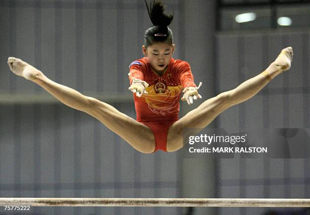 Chinese gymnast Jiang Yuyuan, performs on the uneven bars during qualifying, at the FIG 2007 World Cup Gymnastics event in Shanghai, 27 July 2007....