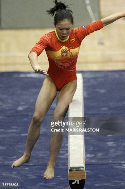 Chinese gymnast Cheng Fei who is the countries number one ranked gymnast for the floor exercise and the vault events, slips off the beam, at the FIG...