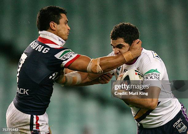 Craig Wing of the Roosters tackles Greg Inglis of the Storm during the round 20 NRL match between the Sydney Roosters and the Melbourne Storm at the...