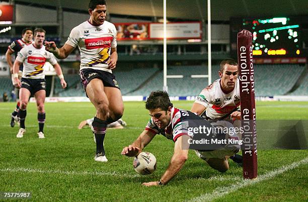 John Williams of the Roosters dives over to score a try during the round 20 NRL match between the Sydney Roosters and the Melbourne Storm at the...