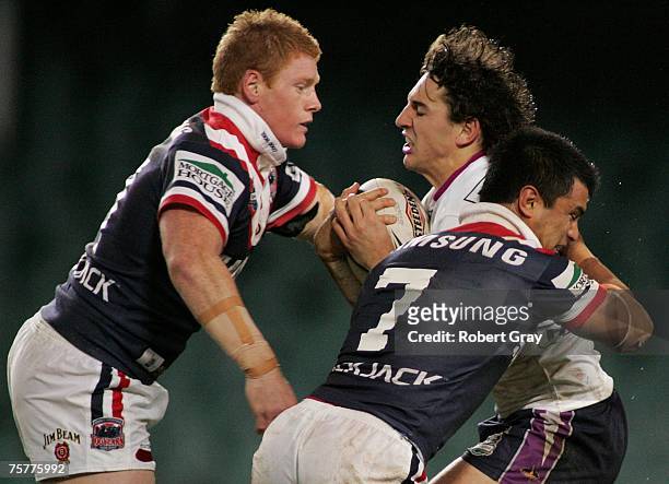 Billy Slater of the Storm is tackled by Shane Shackleton and Craig Wing of the Roosters during the round 20 NRL match between the Sydney Roosters and...
