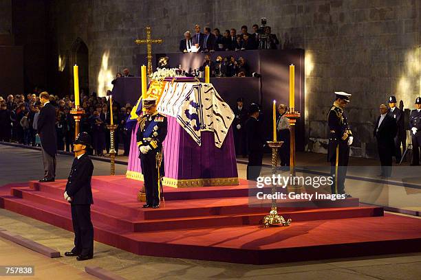 Prince Charles of Britain stands in vigil at the coffin of his grandmother the Queen Mother as it lies in state April 8, 2002 in Westminster Hall,...