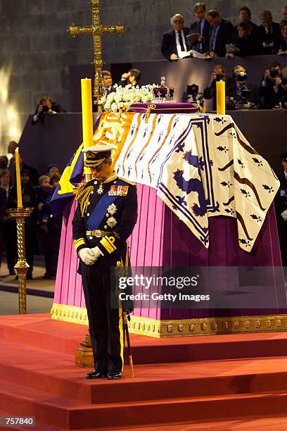 Prince Charles of Britain stands in vigil at the coffin of his grandmother the Queen Mother as it lies in state April 8, 2002 in Westminster Hall,...