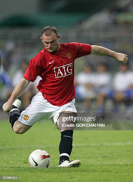 Wayne Rooney of Manchester United scores a penalty against Guangzhou Pharmaceutical FC at the Guangzhou Olympic stadium, in Guangzhou, southern...