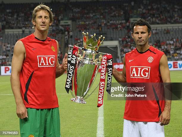 Edwin van der Sar and Ryan Giggs of Manchester United pose with the Premiership trophy ahead of the pre-season friendly between Guangzhuo...