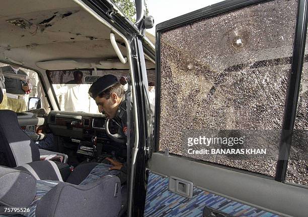 Pakistani policeman inspects the vehicle of Baluchistan provincial spokesman, Raziq Bugti after gunmen shot him dead in Quetta, 27 July 2007. Gunmen...