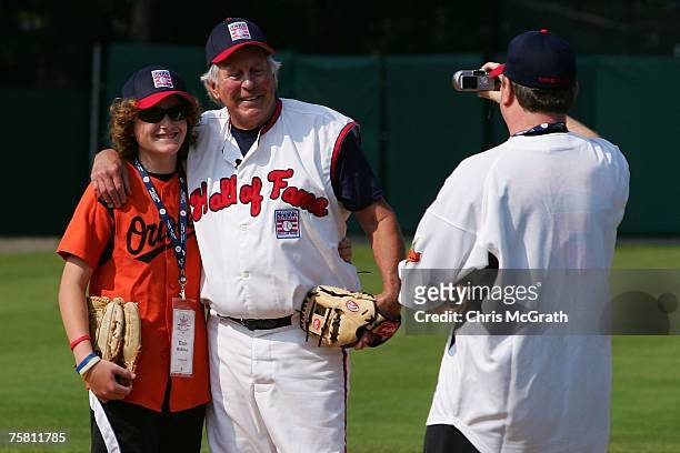 Hall of Fame member Brooks Robinson poses for a photo with fans during the Play Ball with Ozzie Smith Clinic held at Doubleday Field on July 27, 2007...