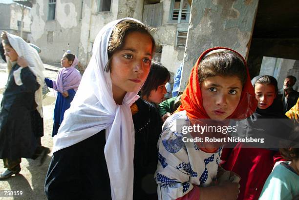 Young girls at the Amir Dost Mohammad Khan school try to find their classroom on the first day of school for the Kabul district March 23, 2002 in...