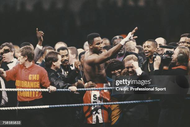Canadian born British heavyweight boxer Lennox Lewis celebrates with members of this entourage and corner team, including manager Frank Maloney ,...
