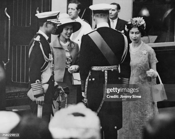 Bhumibol Adulyadej , King of Thailand, and Queen Sirikit are greeted by Queen Elizabeth and Prince Philip at Victoria Station, London, at the start...