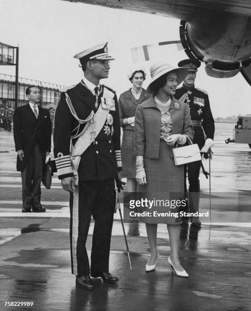 Bhumibol Adulyadej , King of Thailand, and Queen Sirikit at Gatwick Airport at the start of a three-day state visit to Britain, 19th July 1960.